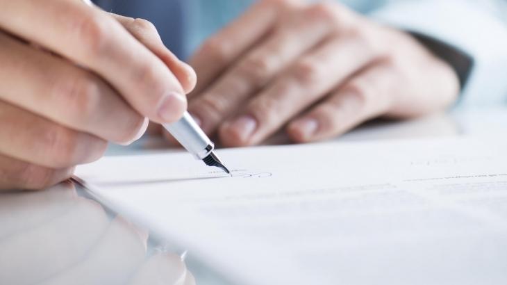 mão assinando um contrato