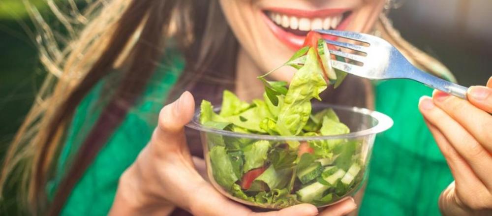 Mulher comendo salada