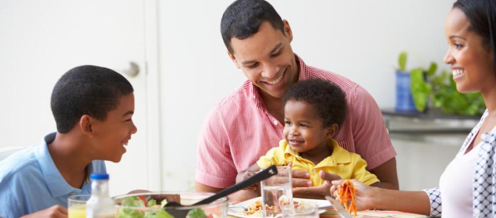 Família fazendo refeição na mesa
